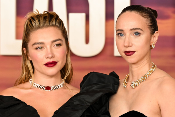Florence Pugh and Zoe Kazan wear bold dark cranberry lipstick and jeweled necklaces with black gowns.
